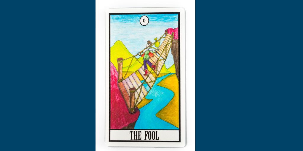 A picture of a card depicting an archetypal fool crossing a bridge
