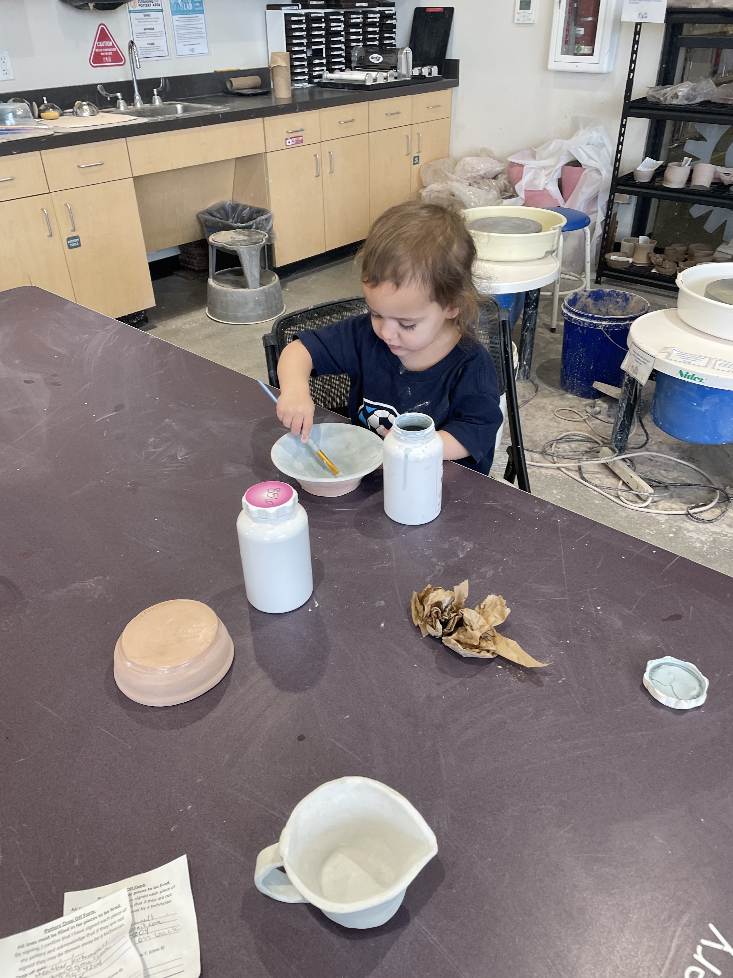 Glazing the bottom of a wheel-thrown pot by me. Over and over.